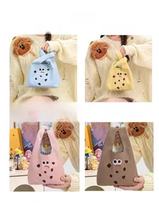 Four colors of cartoon canvas handbags showing blue, yellow, pink, and khaki styles
