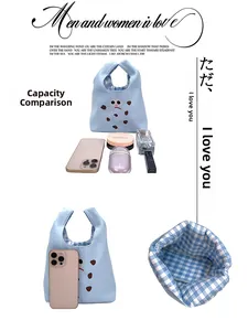 Light blue canvas tote bag featuring funny googly eyes and blue checkered lining detail