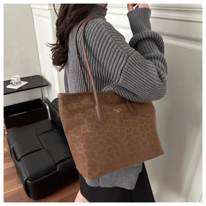 Detailed close-up of brown leopard print tote bag with long shoulder straps for winter
