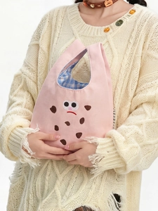 Close-up of pink cookie monster canvas tote bag with embroidery and blue checkered lining