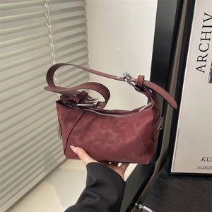 Deep wine red suede crescent shoulder bag with vintage silver buckle and minimalist design