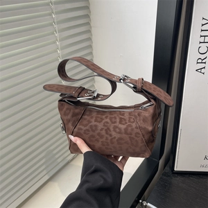 Brown leopard print suede shoulder bag with adjustable strap and silver metal buckle