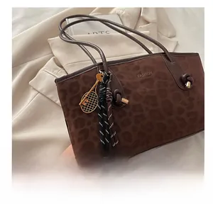 Détail du sac cabas léopard avec breloque raquette de tennis et broderie fashion