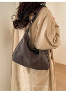 Deep brown matte hobo shoulder bag shown on model with minimalist retro aesthetic vibe