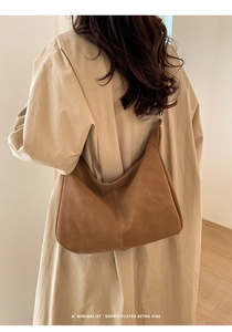 Detailed close-up of brown suede hobo tote showing vintage stitching and soft matte texture