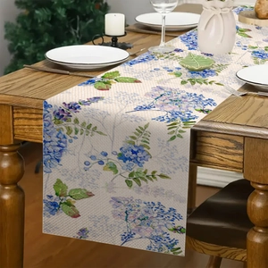 Dettaglio macro del runner da tavola in lino con fiori di iris su tavolo rustico