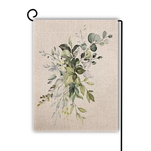 Detail of eucalyptus linen garden flag with watercolor leaves and black metal stand