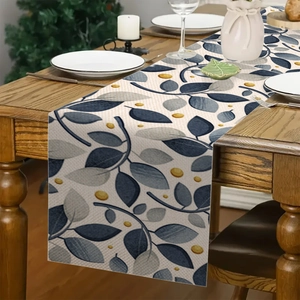 Dettaglio di foglie di eucalipto su runner da tavolo in lino con motivi blu moderni