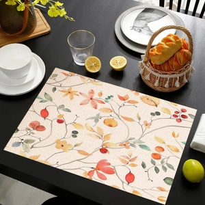 Linen placemat with watercolor eucalyptus leaf pattern on dark wooden dining table