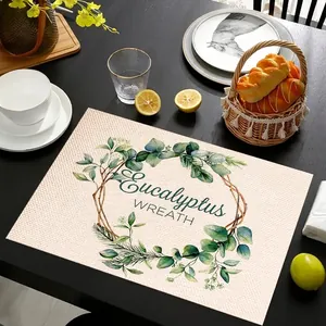 Linen placemat detail with eucalyptus leaf wreath print and decorative woven texture