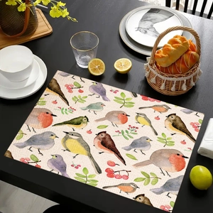 Detailed view of linen placemat featuring watercolor birds and berries on dark wood table