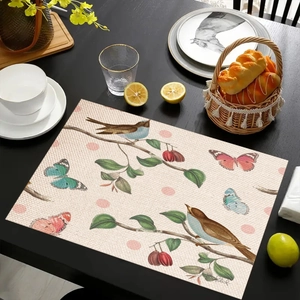Detailed macro of a rectangular linen placemat featuring elegant bird and berry patterns