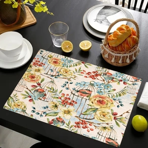 Linen placemat with watercolor floral bird pattern on black wooden dining table setting