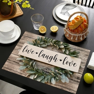 Detail of linen placemat with wood grain pattern and Live Laugh Love text on dark table