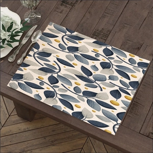 Linen placemat with eucalyptus leaves print on wooden table with western cutlery