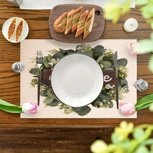 Linen table mat with eucalyptus leaves and wood texture print on dark wooden table