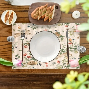 Linen placemat with vintage floral and rabbit print on a rustic wooden table setting