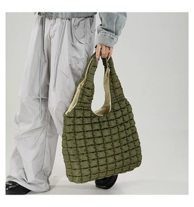 Detail of army green quilted puffer tote bag showing soft texture and large capacity
