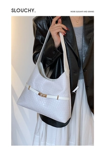 Close-up of white woven leather hobo bag with a gold square metal clasp and texture