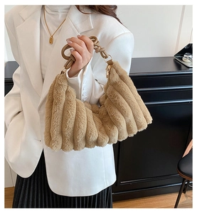 Detail of light brown faux fur shoulder bag with soft textured pleats and knot handle