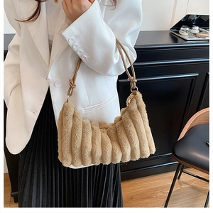 Detail of khaki faux fur shoulder bag featuring vertical pleats and knotted strap accents