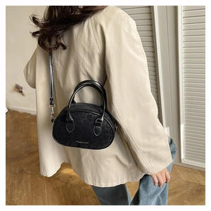 Minimalist black leopard print crossbody bag styled on a model with a casual outfit