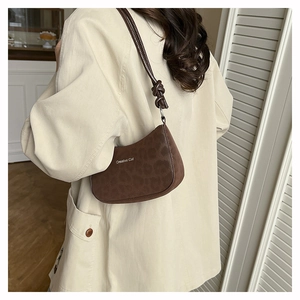 Close-up of Creative Cat brown leopard pattern shoulder bag with knotted strap detail
