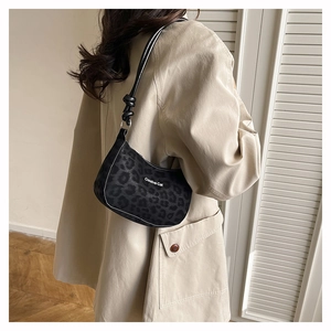 Detail showing the retro leopard print hobo bag worn over the shoulder on a model