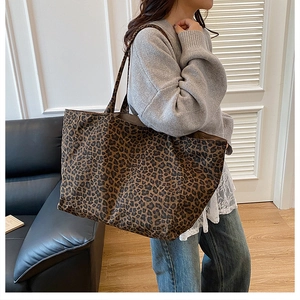 Lifestyle shot of large leopard print tote bag styled for casual outfit with indoor background