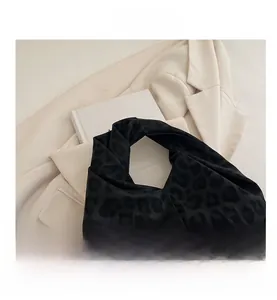Macro detail of high-quality leopard print fabric and soft texture on large tote bag