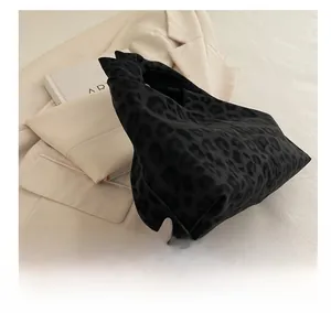 Detail shot of leopard print handbag with pleated cloud texture and suede-like fabric