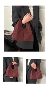 Macro detail of wine red leopard print handbag showing suede texture and pleated structure