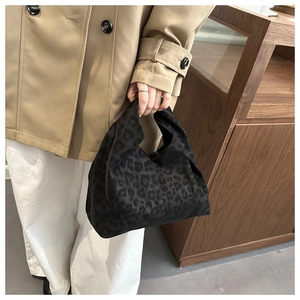 Detail of the black leopard pattern on the soft suede textured commuter tote bag