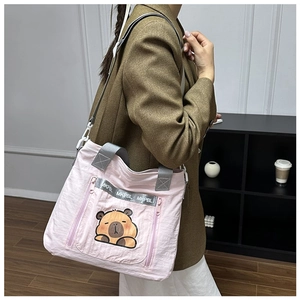 Detailed view of pink capybara printed canvas bag with adjustable strap and side zipper pocket