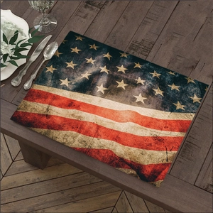 Vintage American flag linen placemat with rustic texture on dark wooden dining table