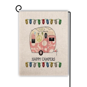 Detail of linen garden flag featuring a vintage pink camper with Happy Campers text