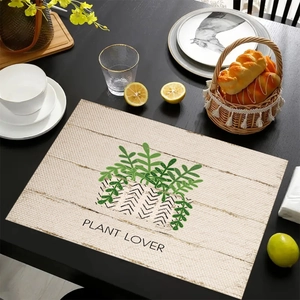Linen placemat with green plants and Plant Lover text on a rustic wooden dining table