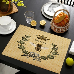Detailed view of linen placemat featuring honeycomb print and Bee Kind bee crown motif