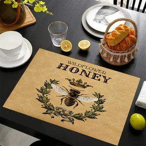 Detailed close-up of a rustic linen placemat featuring a vintage bee and wildflower honey print