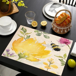 Close-up of linen placemat featuring vibrant bee and floral watercolor patterns