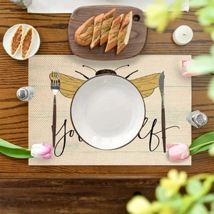 Linen placemat with bee print and Bee Yourself text on dark wooden table