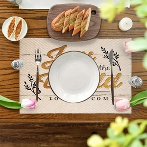 Christmas linen placemat with Joy to the world print and holiday wreath decoration