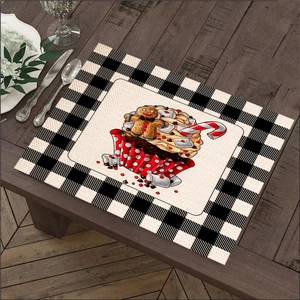 Christmas linen placemat featuring gingerbread man and cupcake with checkered border