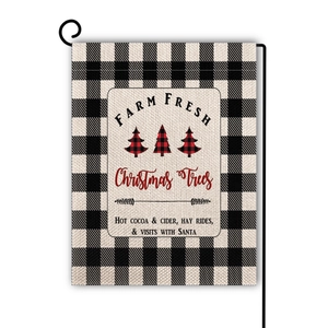 Detailed view of burlap Christmas garden flag with plaid trees on a black metal stand