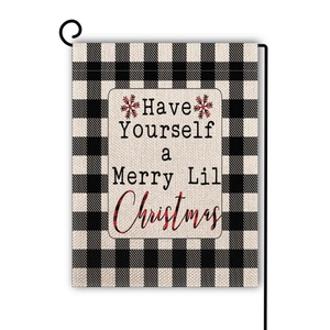 Detail of Christmas garden flag with buffalo check pattern and holiday text on a stand