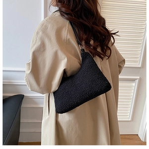 Plush faux fur shoulder bag in black with smooth leather strap for winter fashion