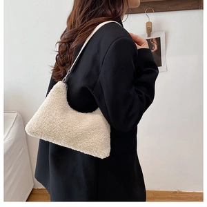 Detail of off-white faux fur shoulder bag with teddy texture and slim leather strap