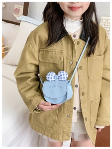Detail of light blue crossbody bag with checkered bow and cat embossing for kids
