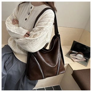Dettaglio borsa tote in pelle marrone scuro vintage con doppie cerniere in argento