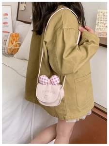 Pink toddler crossbody bag with cute cat print and plaid bow shown on a child model